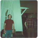 Unknown Crew member poses while Henry Works